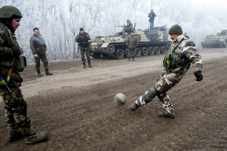 Ukrainian soldiers playing football on the frontline